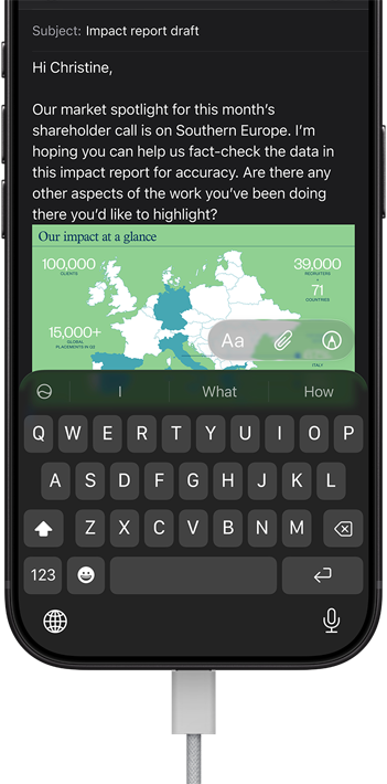 iPhone 18 Pro, black, connected to a charger, screen shows a work email in Mail
