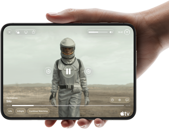 iPhone Duo, held with one hand, opened in horizontal orientation, fully unfolded, interior screen displays Apple TV show "Silo"