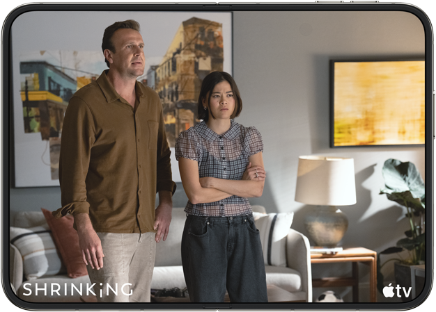 iPhone Duo, opened in horizontal position, Apple TV show "Shrinking" plays on screen