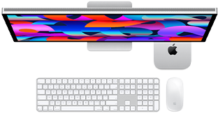 Mac mini tucked under Studio Display, Magic Keyboard with numeric keypad, Magic Mouse