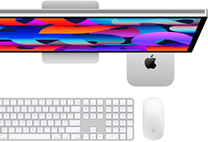 Mac mini tucked under Studio Display, Magic Keyboard with numeric keypad, Magic Mouse