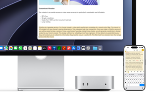 Mac mini front, tucked under Studio Display, an iPhone sits to the right of the device and the display, text selected with cut, copy, paste and AutoFill commands above on iPhone matches highlighted text on display, showcasing Universal Clipboard