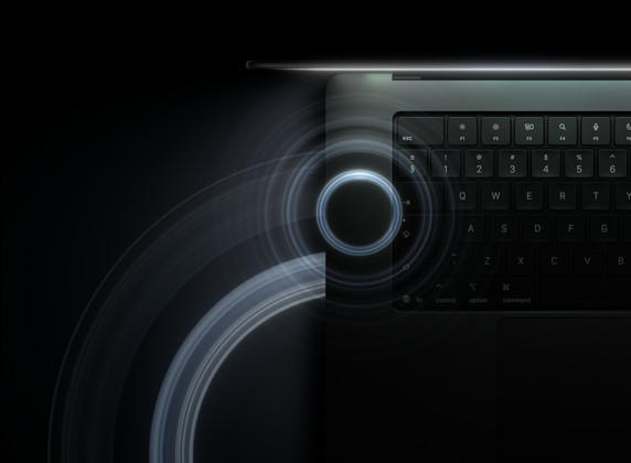 MacBook Pro with PROLED XDR Display, open lid, space black colour, keyboard lit by glow from display, circles depicting sonic waves emanate from top and left side of laptop body