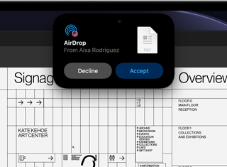 Display shows Dynamic Island with an AirDrop request in a small window over an open Adobe Acrobat file