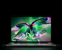 MacBook Pro with PROLED XDR Display, open lid, silver colour, display shows detailed, high-contrast image with vivid colours, screen illuminates keyboard
