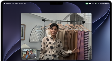 A video call on a MacBook Pro where a woman shows fabrics to two people on the call, with Centre Stage keeping her centred in the frame as she moves around