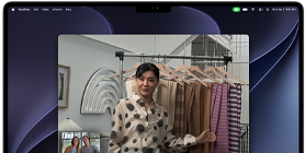 A video call on a MacBook Pro where a woman shows fabrics to two people on the call, with Centre Stage keeping her centred in the frame as she moves around