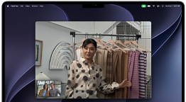 A video call on a MacBook Pro where a woman shows fabrics to two people on the call, with Centre Stage keeping her centred in the frame as she moves around